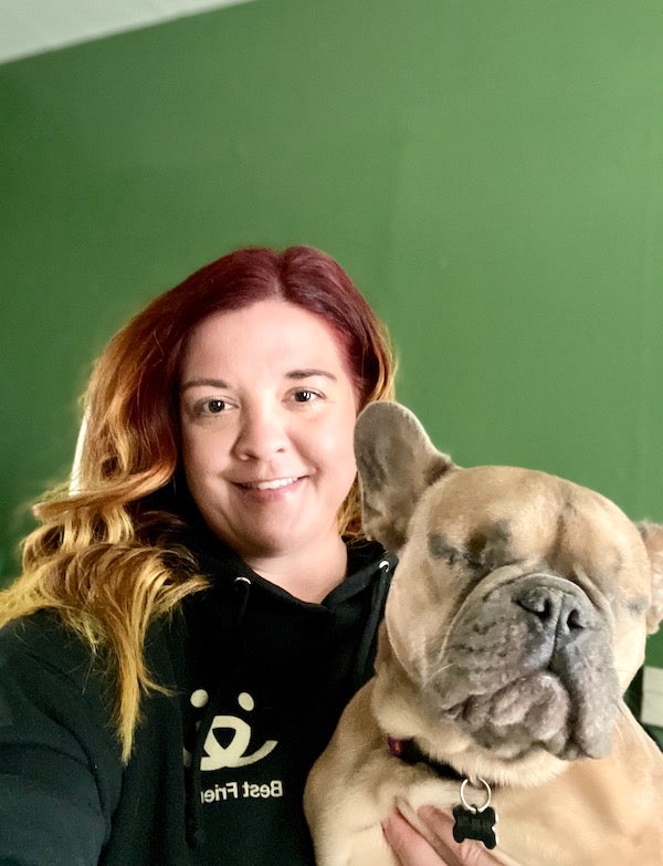Caitlin Lisle of Best Friends Animal Society holding one of her dogs