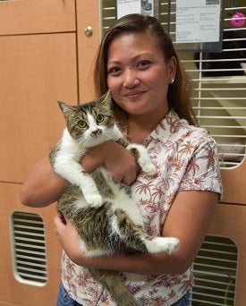 Woman holding tabby and white kitten