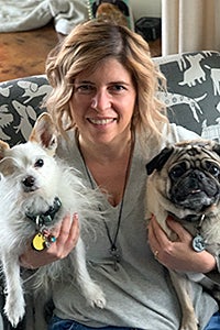 Stacy Rogers holding two dogs