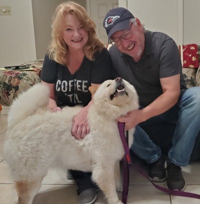 man and woman with a newly adopted chow dog