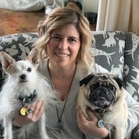 Stacy Rogers holding her two dogs