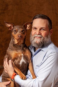 Tim Yeaglin holding brown dog