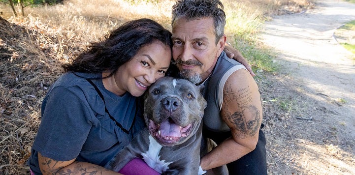 Couple with gray dog