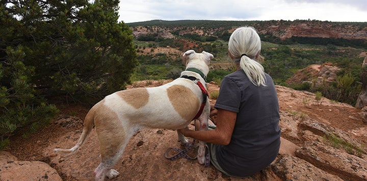 Woman and dog looking at the scenery at Best Friends Animal Sanctuary